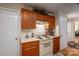 Kitchen features wood cabinets, electric range, and tile countertops at 1335 Huckleberry Dr, Lincolnton, NC 28092