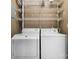 Stackable washer and dryer in laundry closet with wire shelving at 1623 12Th Ne St, Hickory, NC 28601