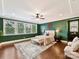 Main bedroom with green walls, hardwood floors, and ceiling fan at 17422 Hawkwatch Ln, Charlotte, NC 28278