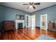 Bright bedroom with hardwood floors, fireplace and ceiling fan at 203 E Congress St, Lincolnton, NC 28092