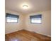 Well-lit bedroom with hardwood floors and two windows at 8308 Kerrybrook Cir, Charlotte, NC 28214