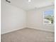 Bright bedroom with gray carpet and a window at 1050 Bull Dog Ln, Wingate, NC 28174