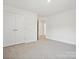 Simple bedroom with gray carpet and double doors at 1050 Bull Dog Ln, Wingate, NC 28174