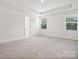 Spacious bedroom with carpet flooring and two windows at 1050 Bull Dog Ln, Wingate, NC 28174