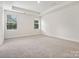 Light-filled bedroom with carpet and two windows at 1050 Bull Dog Ln, Wingate, NC 28174