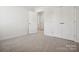 Bedroom with gray carpet, double doors and access to bathroom at 1050 Bull Dog Ln, Wingate, NC 28174