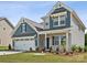Two-story house with gray siding, white trim, and a two-car garage at 1050 Bull Dog Ln, Wingate, NC 28174