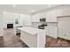 Modern kitchen with white cabinets, quartz countertops, and stainless steel appliances at 1050 Bull Dog Ln, Wingate, NC 28174