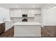 Modern kitchen with white cabinets, stainless steel appliances, and a large island at 1050 Bull Dog Ln, Wingate, NC 28174