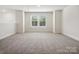 Spacious loft area with gray carpet and large windows at 1050 Bull Dog Ln, Wingate, NC 28174