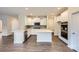 Modern kitchen with white cabinets and an island at 145 Dogwood Grove Pl, Troutman, NC 28166