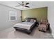 Bedroom with a bed, chair, and olive green accent wall at 1525 Lansdale Dr # F, Charlotte, NC 28205