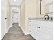 Bathroom with granite countertop, white cabinets and vinyl flooring at 2668 Polo Ln, Maiden, NC 28650