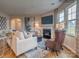 Cozy living room featuring a fireplace and large windows at 277 Hamptons Cove Rd, Troutman, NC 28166