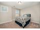 Cozy bedroom with a floral-patterned bedspread at 3030 Stephen Pace Trl, Huntersville, NC 28078