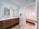 Modern bathroom with a double vanity, large mirrors, and a walk-in shower at 3625 Tuckaseegee Rd, Charlotte, NC 28208