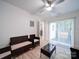 Cozy living room featuring wicker furniture and a glass coffee table, leading to a patio at 3625 Tuckaseegee Rd, Charlotte, NC 28208