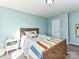 Light teal bedroom with a full-size bed and window at 4021 Eckels Dr, Charlotte, NC 28215