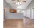 Open concept living room and kitchen with hardwood floors and neutral walls at 5136 Wheat Sw Dr, Concord, NC 28027