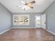 Bright living room featuring hardwood floors, vaulted ceilings and a ceiling fan at 5136 Wheat Sw Dr, Concord, NC 28027