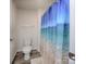 Simple bathroom with white toilet and blue ocean shower curtain at 7865 Whispering Stream Dr, Sherrills Ford, NC 28673