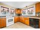 Kitchen with wood cabinets, white appliances, and tile flooring at 1235 10Th Ne St, Hickory, NC 28601