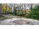 Small brick patio in backyard surrounded by trees and landscaping at 1235 10Th Ne St, Hickory, NC 28601