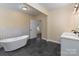 Bathroom with double vanity, free-standing tub, and view to backyard at 305 Elm St, Lancaster, SC 29720