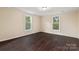 Bright bedroom with dark hardwood floors and two windows at 305 Elm St, Lancaster, SC 29720