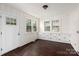 Bright dining area with wood-paneled walls and hardwood floors at 305 Elm St, Lancaster, SC 29720