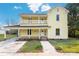 Two-story yellow house with a front porch and landscaped yard at 305 Elm St, Lancaster, SC 29720