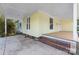 Side view of the home's front porch with brick steps and a parking area at 305 Elm St, Lancaster, SC 29720