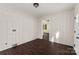 Bright laundry room with dark wood floors and built-in storage at 305 Elm St, Lancaster, SC 29720