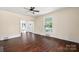 Living room with hardwood floors, large windows, and access to entryway at 305 Elm St, Lancaster, SC 29720