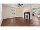 Living room with hardwood floors, fireplace, and views to the kitchen at 305 Elm St, Lancaster, SC 29720