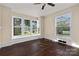Living room featuring bay windows, dark hardwood floors, and an abundance of natural light at 305 Elm St, Lancaster, SC 29720