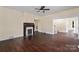 Living room with hardwood floors, fireplace, and access to hallway at 305 Elm St, Lancaster, SC 29720