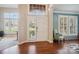 Bright entryway with hardwood floors, white door, and plantation shutters at 3405 Abbey Hill Ln, Charlotte, NC 28210