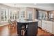 Modern kitchen island with a dark base, granite countertop, and open shelving at 3405 Abbey Hill Ln, Charlotte, NC 28210