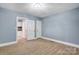 Spacious bedroom with light grey walls and hardwood floors at 3703 Margaret Wallace Rd, Matthews, NC 28105