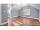 Well-lit bedroom featuring hardwood floors and large windows at 3703 Margaret Wallace Rd, Matthews, NC 28105