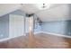 Bonus room with hardwood floors, built-in closet, and neutral wall colors at 3703 Margaret Wallace Rd, Matthews, NC 28105