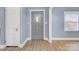 Gray entryway with hardwood floors and a gray door at 3703 Margaret Wallace Rd, Matthews, NC 28105