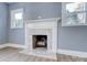 Fireplace with marble surround in a living room with hardwood floors at 3703 Margaret Wallace Rd, Matthews, NC 28105