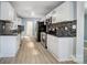 Renovated kitchen featuring white cabinets and granite countertops at 3703 Margaret Wallace Rd, Matthews, NC 28105