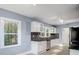 Modern kitchen with white cabinets and granite countertops at 3703 Margaret Wallace Rd, Matthews, NC 28105