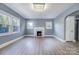 Living room with hardwood floors, fireplace, and neutral walls at 3703 Margaret Wallace Rd, Matthews, NC 28105