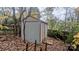 Gray storage shed with double doors in backyard at 3703 Margaret Wallace Rd, Matthews, NC 28105