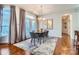 Bright dining area with hardwood floors, large windows, and a modern dining table at 8235 Parknoll Dr, Huntersville, NC 28078