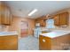 L-shaped kitchen with ample counter space and wood cabinets at 103 Prestwick Ct, Salisbury, NC 28146